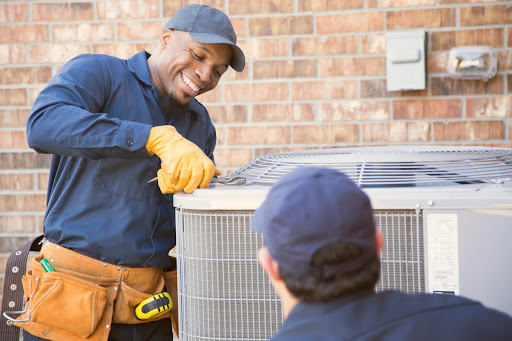 HVAC technician fixing air conditioning unit
