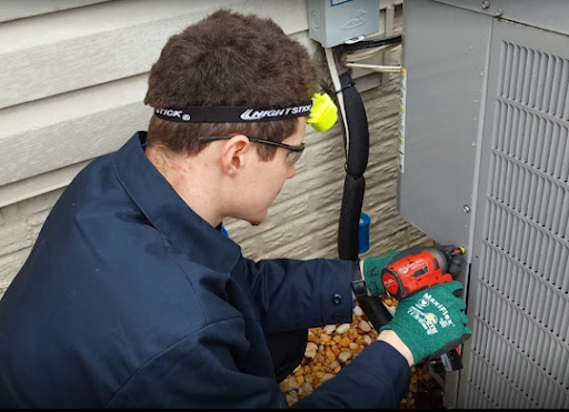 Allgood HVAC technician working on repairing a broken AC unit