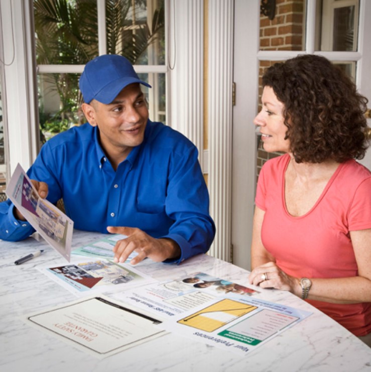 Allgood technician discussing plumbing and HVAC services with client in Lawrenceville, GA.